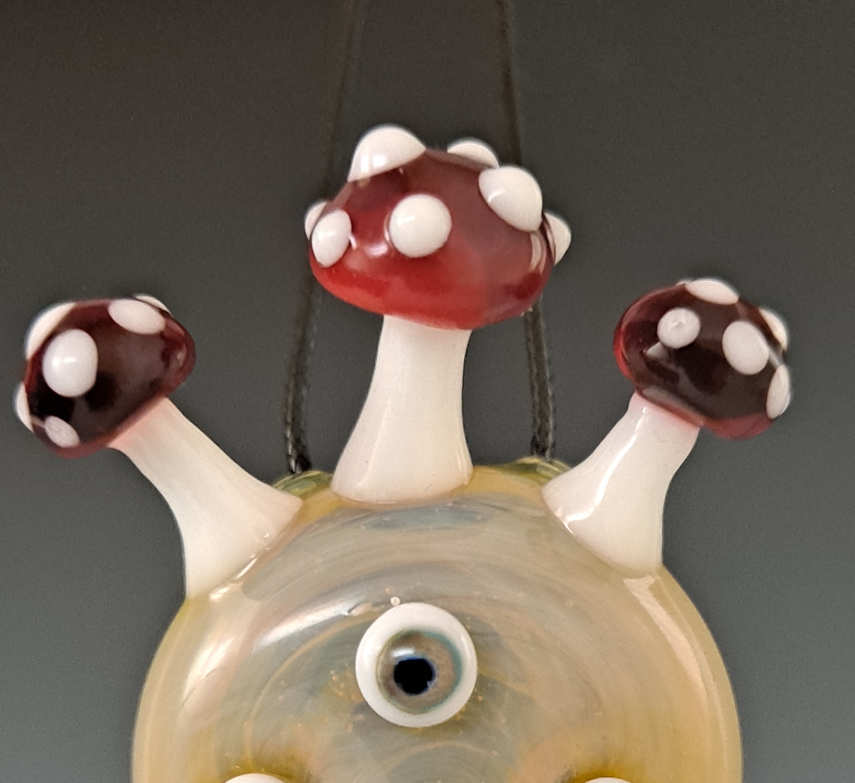 a glass figurine with three eyes on it