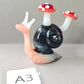 Glass snail with mushroom-shaped shells on a gray background